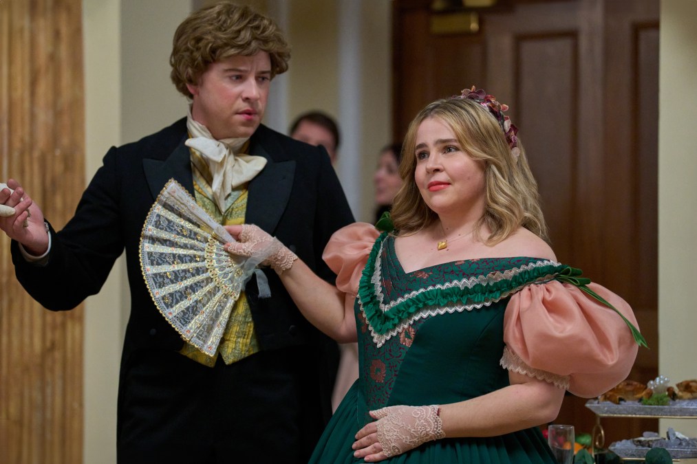 Killian Cole stands next to Mae Whitman who holds a fan