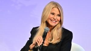 Christie Brinkley smiling onstage