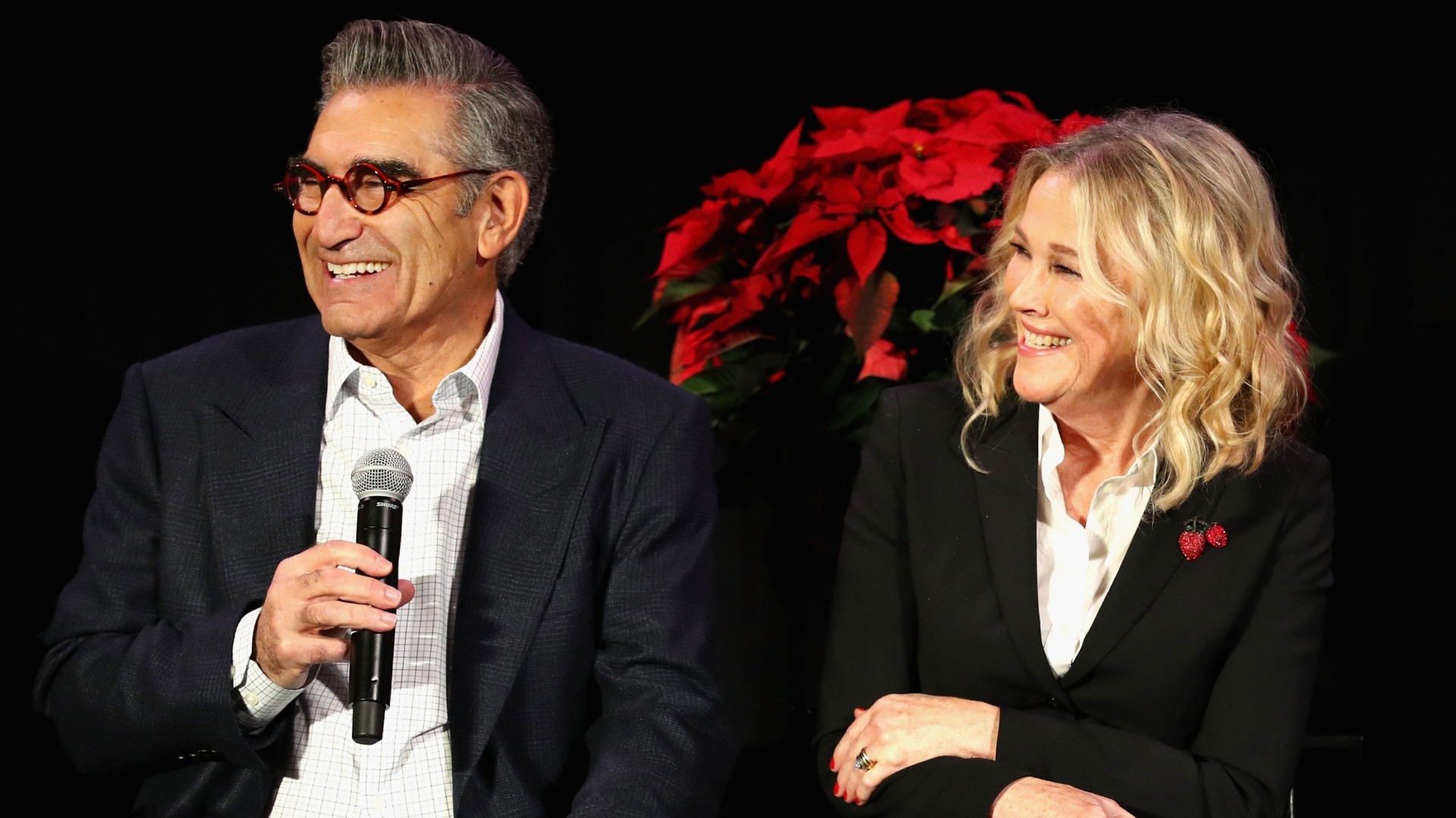 Eugene Levy and Catherine O'Hara smiling onstage