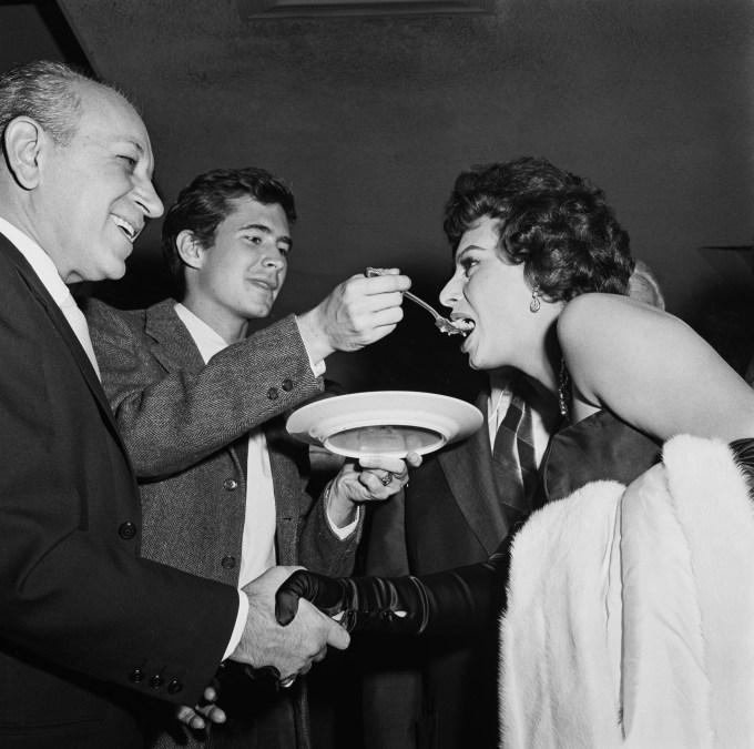 George Raft, Sophia Loren and Anthony Perkins attend an event 
