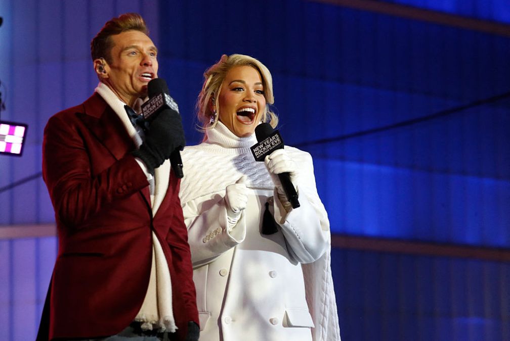 Ryan Seacrest and Rita Ora speak as revelers gather to celebrate New Year's Eve in Times Square