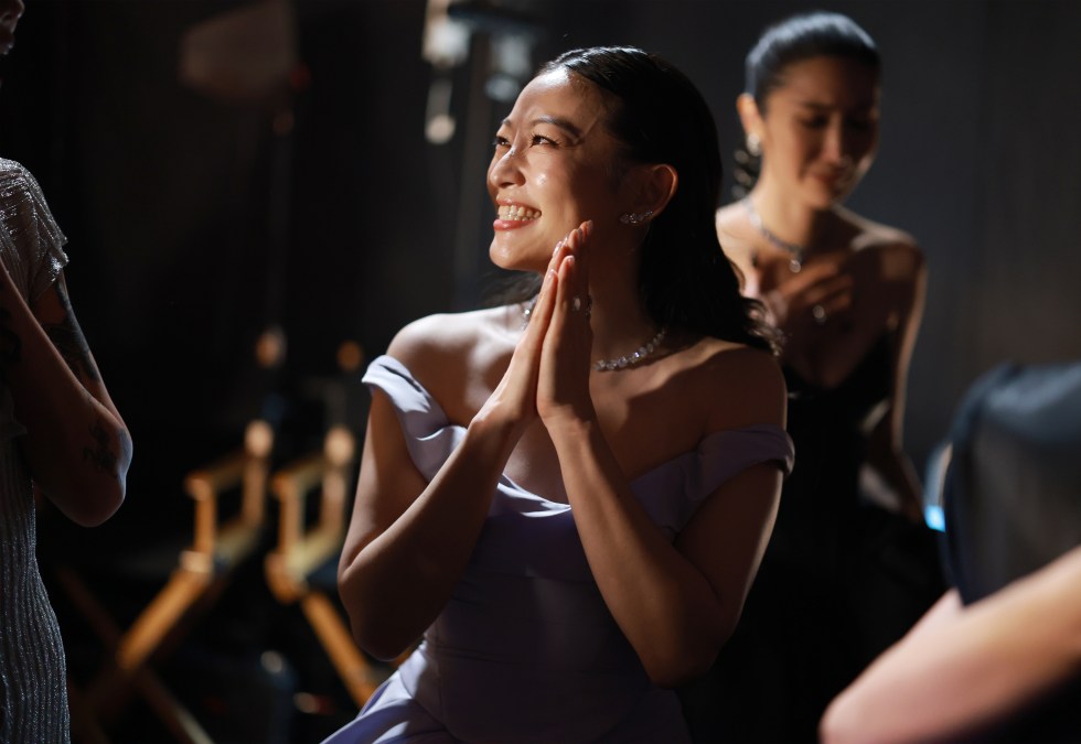 Arden Cho smiling with her hands together