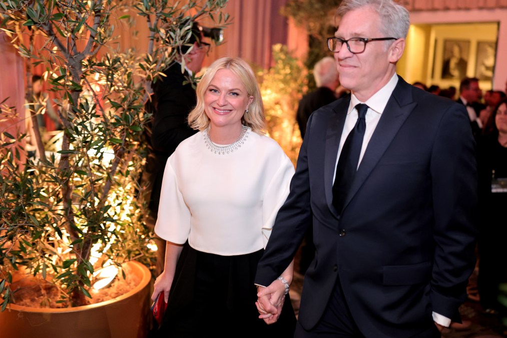 Amy Poehler and Joel Lovell holding hands