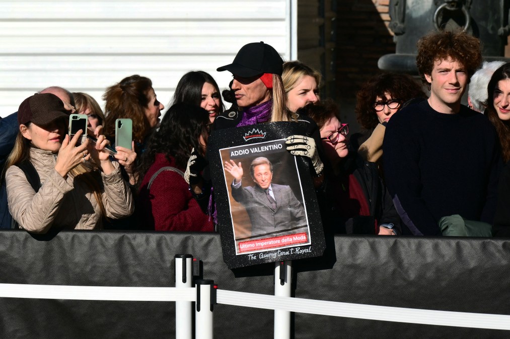 People stand outside the Basilic of Santa Maria degli Angeli e dei Martiri during the funeral ceremony