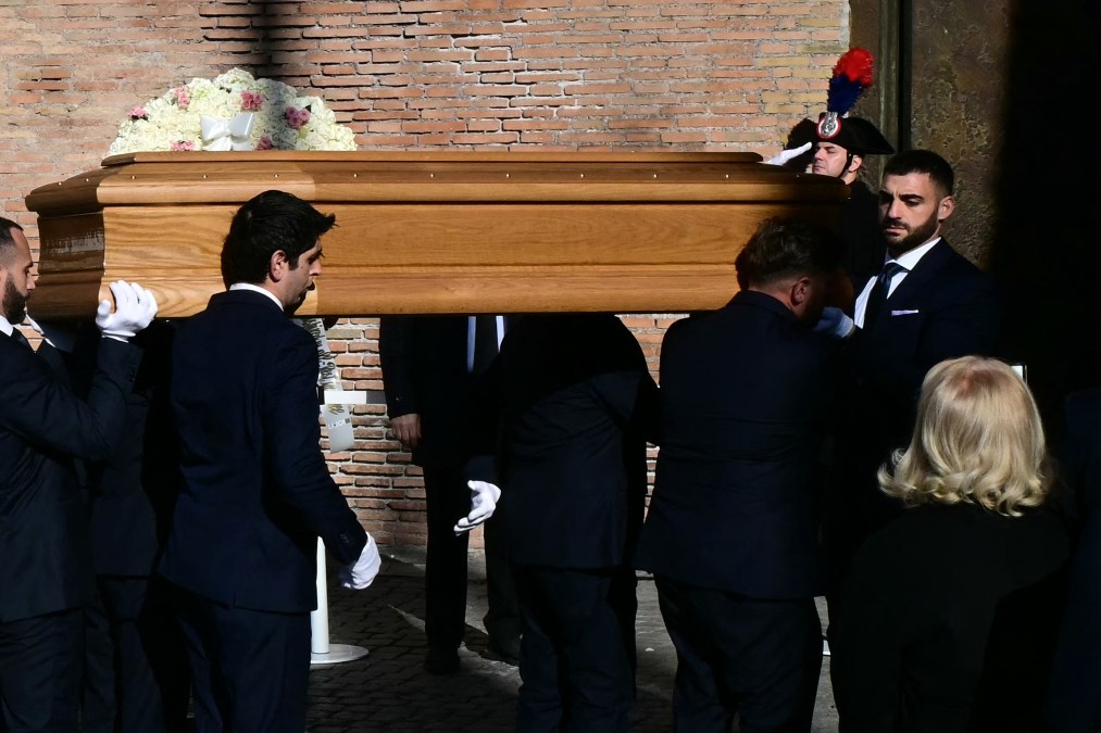 Pallbearers carry the coffin of the late Italian fashion designer Valentino Gavarani