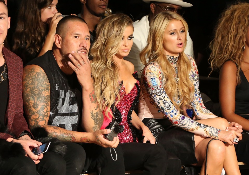 Carmen Electra (L) and Paris Hilton attend The Blonds fashion show during MADE Fashion Week Spring 2015 