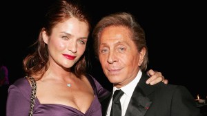 Model Helena Christiensen and designer Valentino Garavani pose for photos