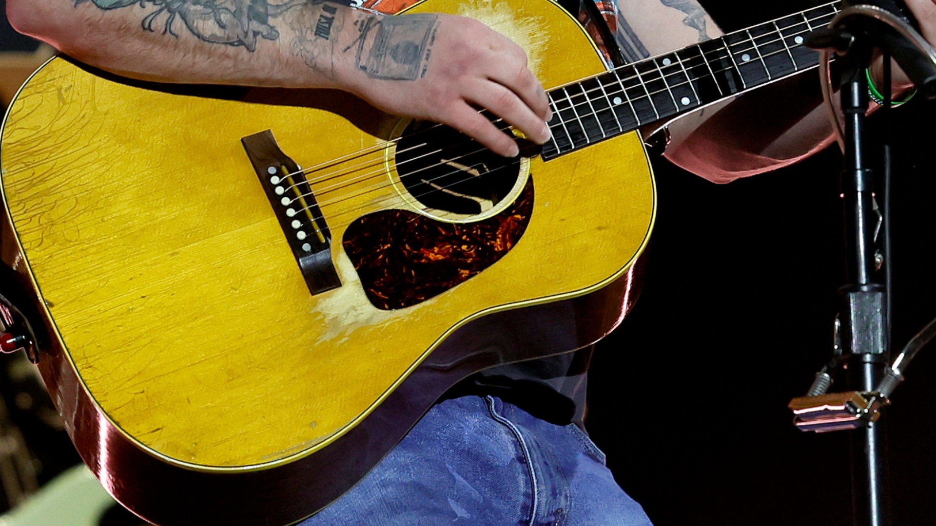 Close up of Zach Bryan's hand and guitar