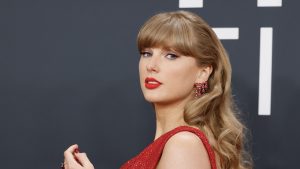 Taylor Swift poses in red dress