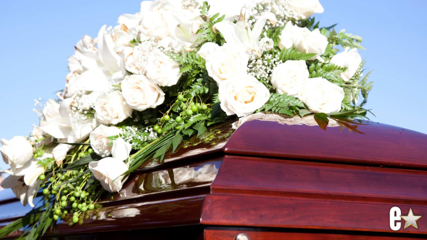 coffin with flowers ontop of it