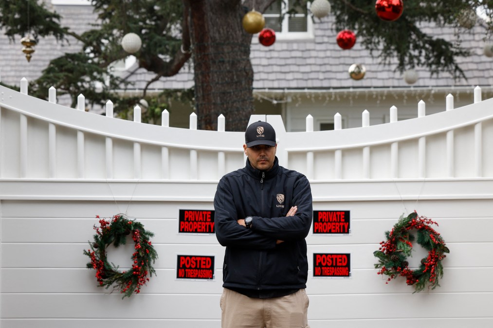 A security guard stands outside US actor and director Rob Reiner's mansion