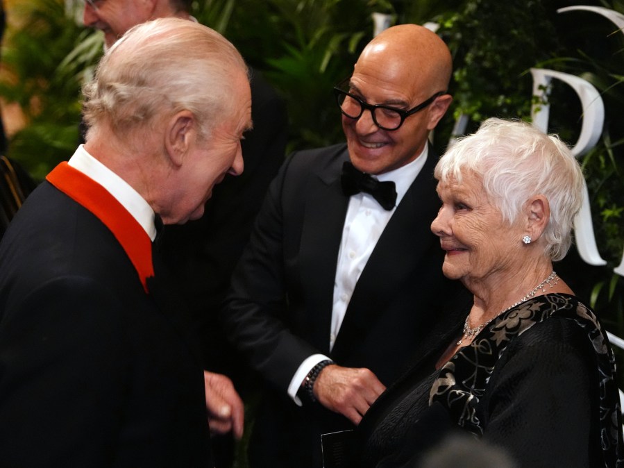 Dame Judi Dench (R) with King Charles III and Stanley Tucci in 2026.