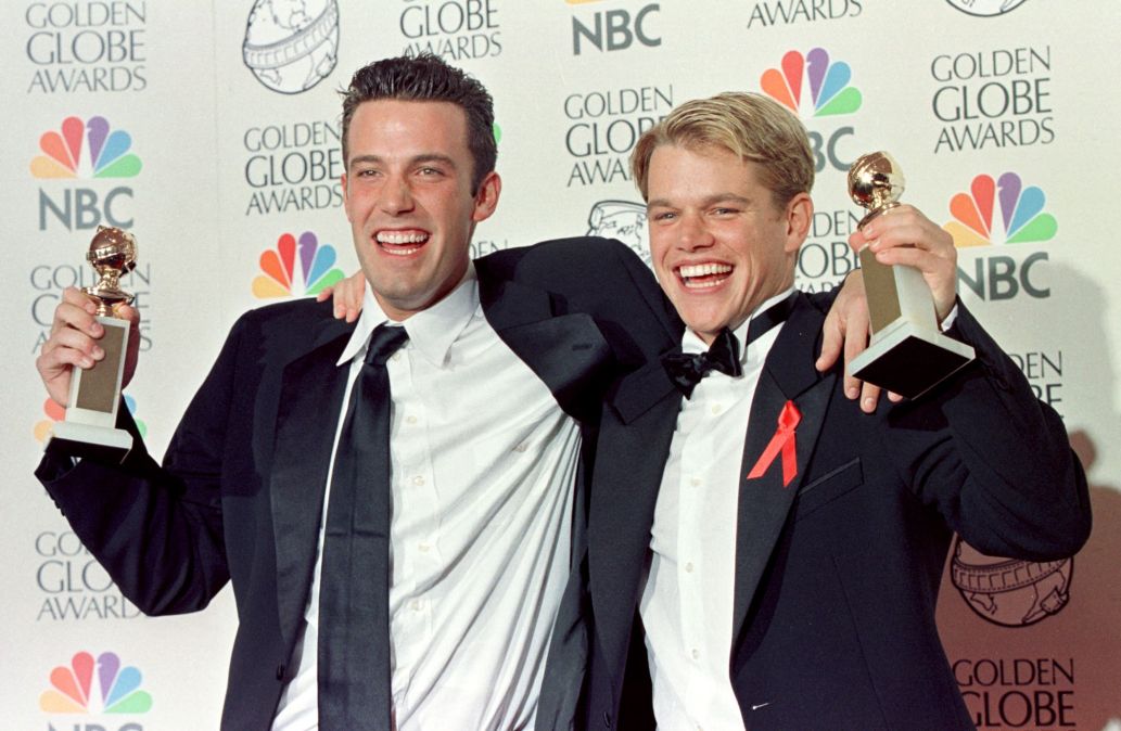 Matt Damon and Ben Affleck hold up Golden Globe awards for Best Screenplay for "Good Will Hunting"