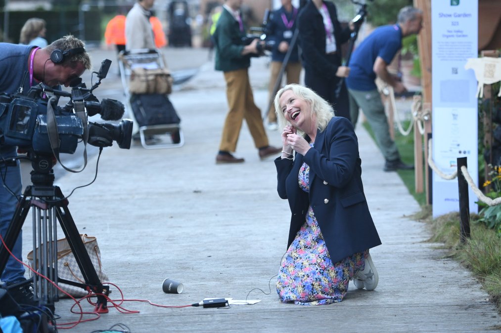 Chelsea Flower Show..Carol Kirkwood On The Ground Chasing A Blind Dog During Filming Today ....Evening Standard Picture