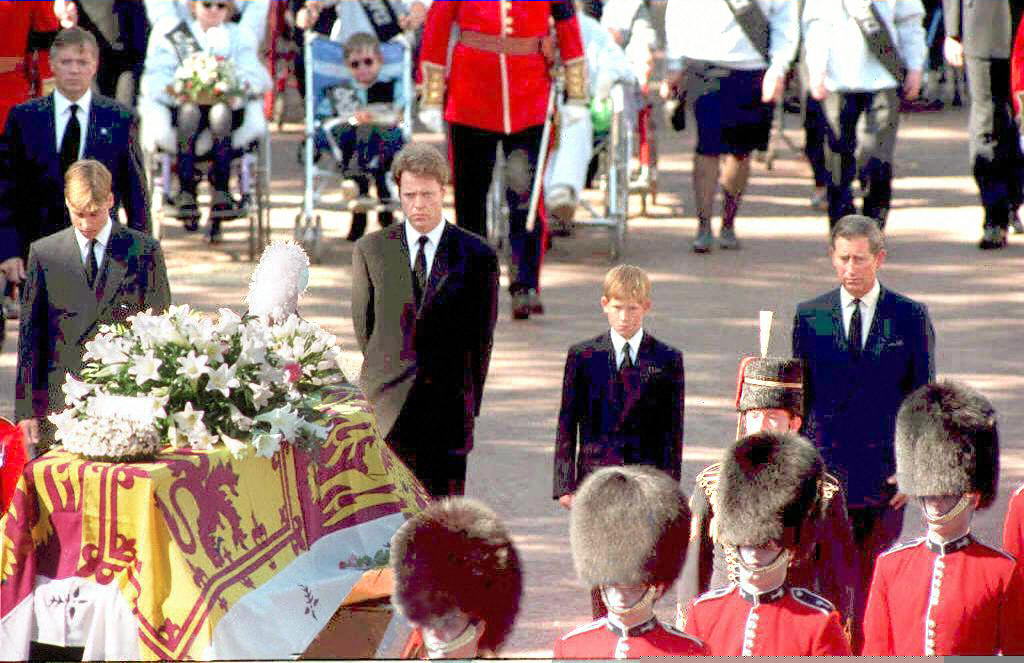The sons of Diana, Princess of Wales, her brother and her former husband, the Prince of Wales, somberly walk behind her coffin as the funeral procession approaches Westminster Abbey 06 September.