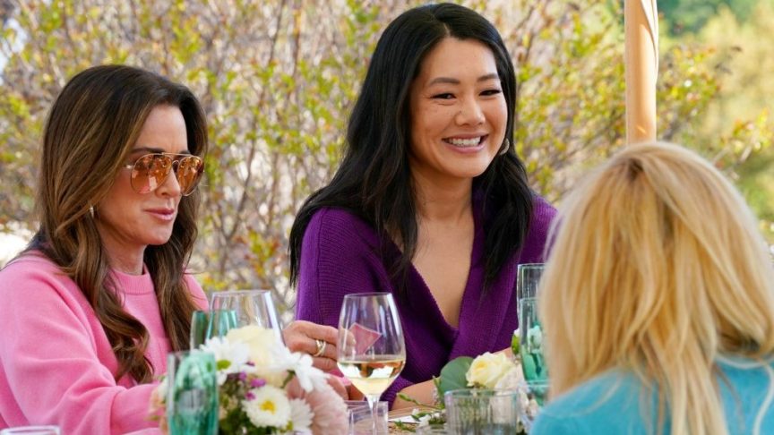 Crystal Kung Minkoff smiling with Kyle Richards during a scene on The Real Housewives of Beverly Hills