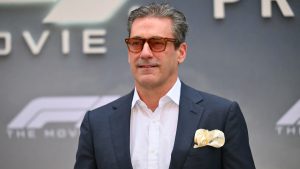 Jon Hamm attends the “F1” premiere in Times Square wearing a navy suit and sunglasses