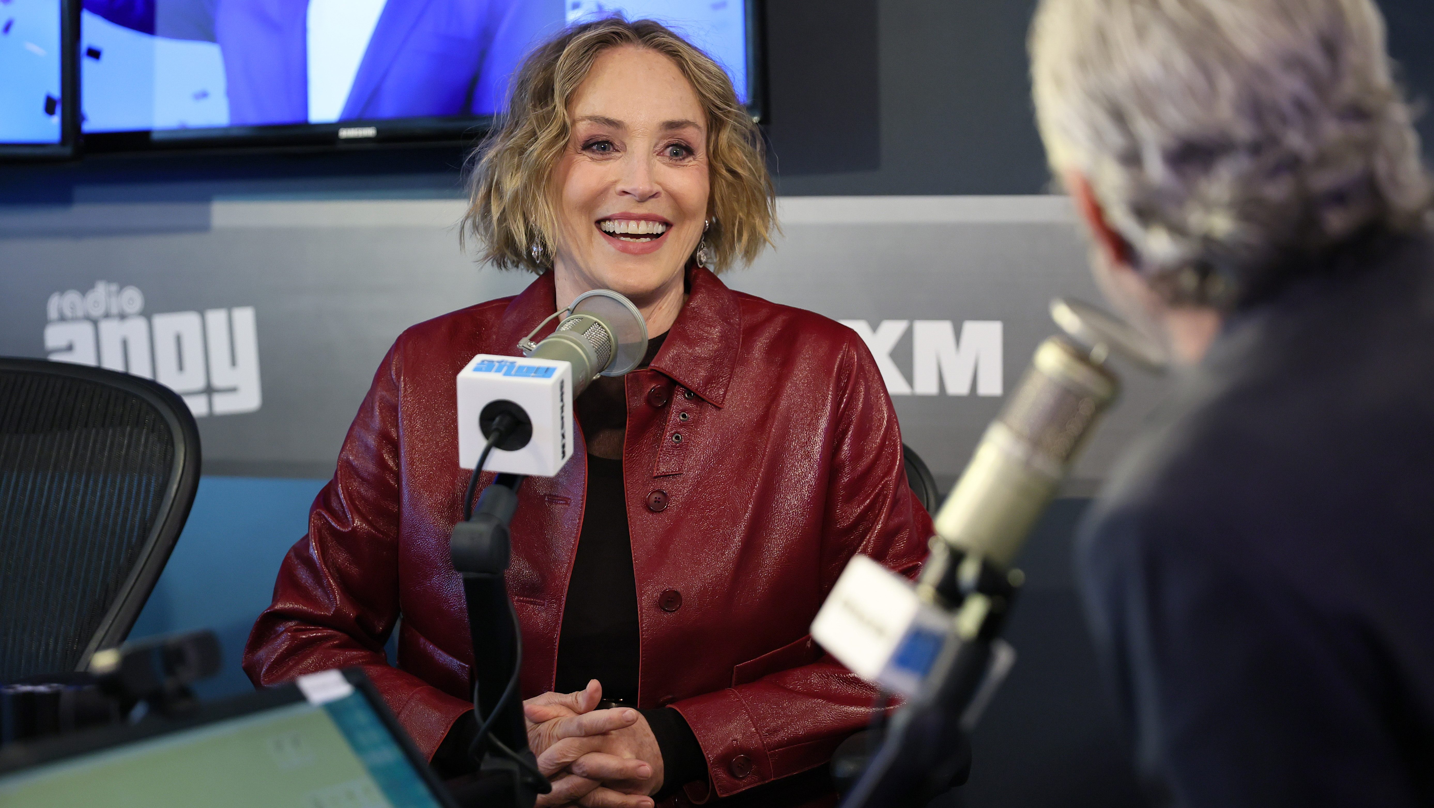 Andy Cohen (R) interviews Sharon Stone during her visit to SiriusXM Studios.