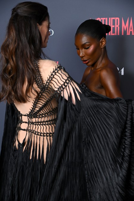 Anne Hathaway covers Michaela Coel as she adjusts her dress 
