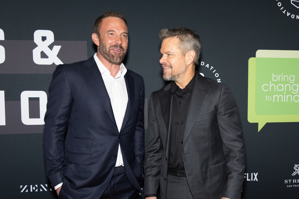 Ben Affleck and Matt Damon laughing while they attend an event