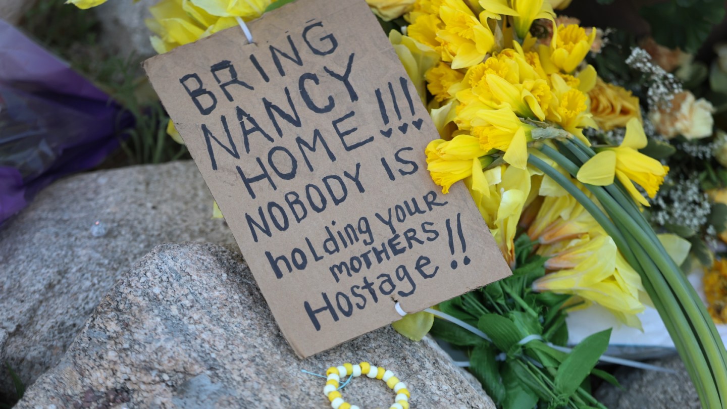 Flowers and poster about Nancy Guthrie
