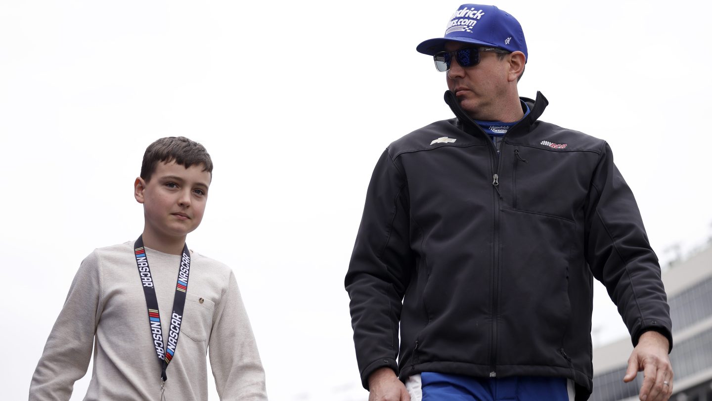 Kyle Busch walks with son Brexton Busch before a NASCAR Craftsman Truck Series race at EchoPark Speedway in February 2026.