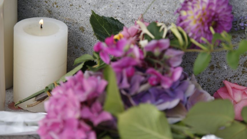 A candle and flowers for Charles Cioffi.