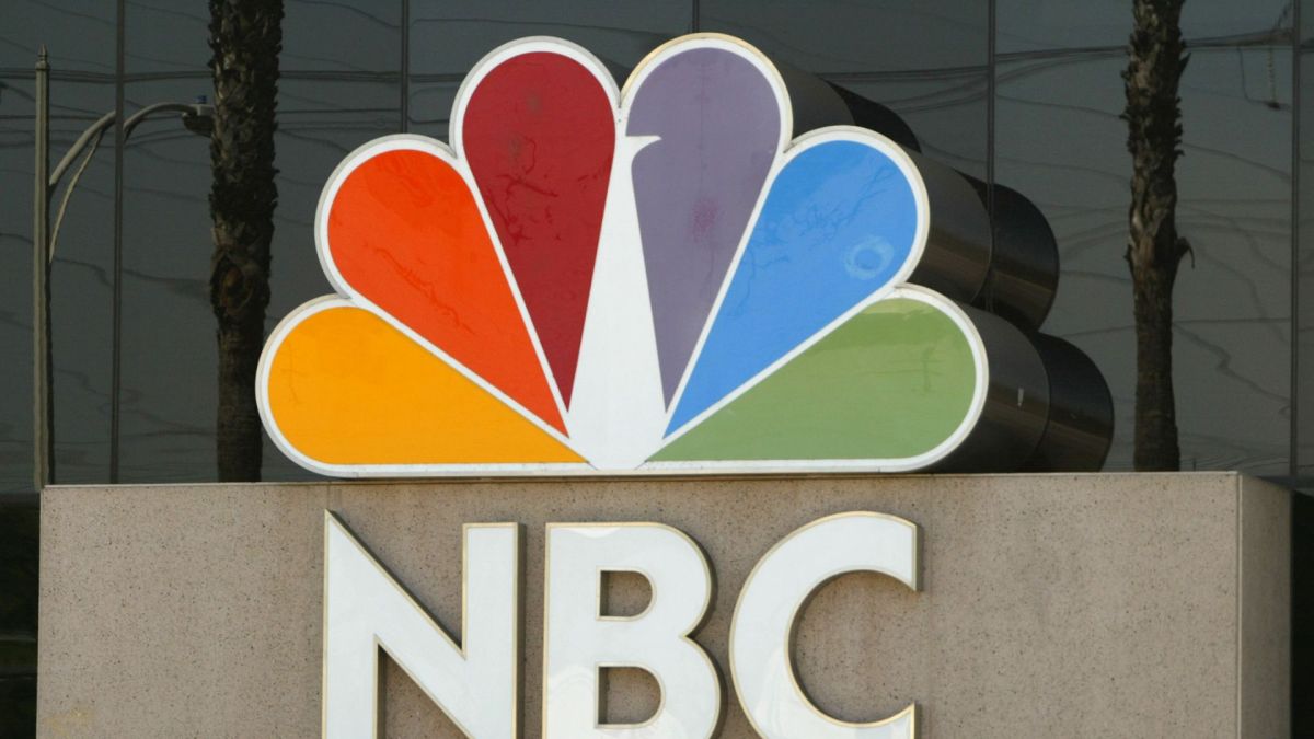 The NBC peacock logo is seen on the NBC studios building August 28, 2003 in Burbank, California. Paris-based Vivendi is in the final stages of a long and drawn-out auction of its U.S.-based media assets, collectively known as Vivendi Universal Entertainment, or VUE. NBC is an auction favorite