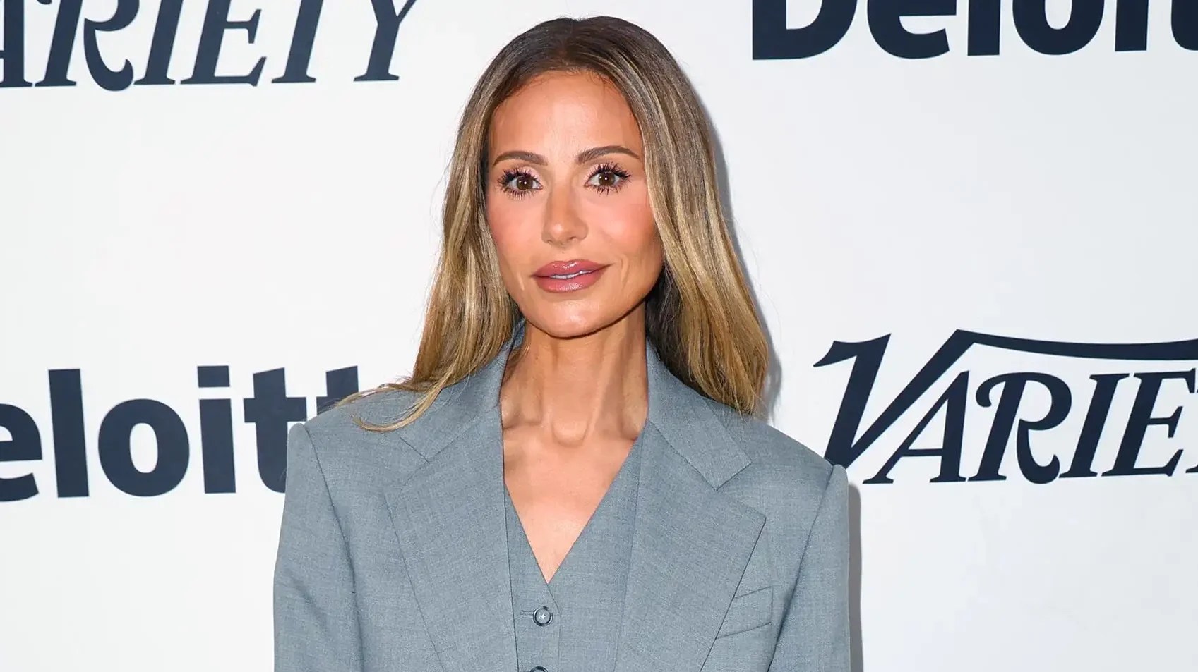 Dorit Kemsley poses in a champagne-colored dress amid news of a new foreclosure sale date for her Encino home.