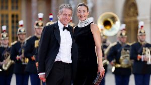 English actor Hugh Grant and his Swedish producer wife, Anna Eberstein, arrive to attend a state banquet at the Palace of Versailles on the first day of a British royal state visit to France. Britain's King Charles III and his wife Queen Camilla are on a three-day state visit to France.