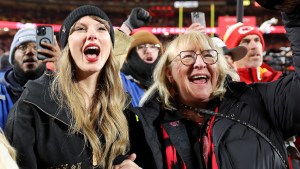 Taylor Swift and Donna Kelce cheering on Travis Kelce during a Kansas City Chiefs game.