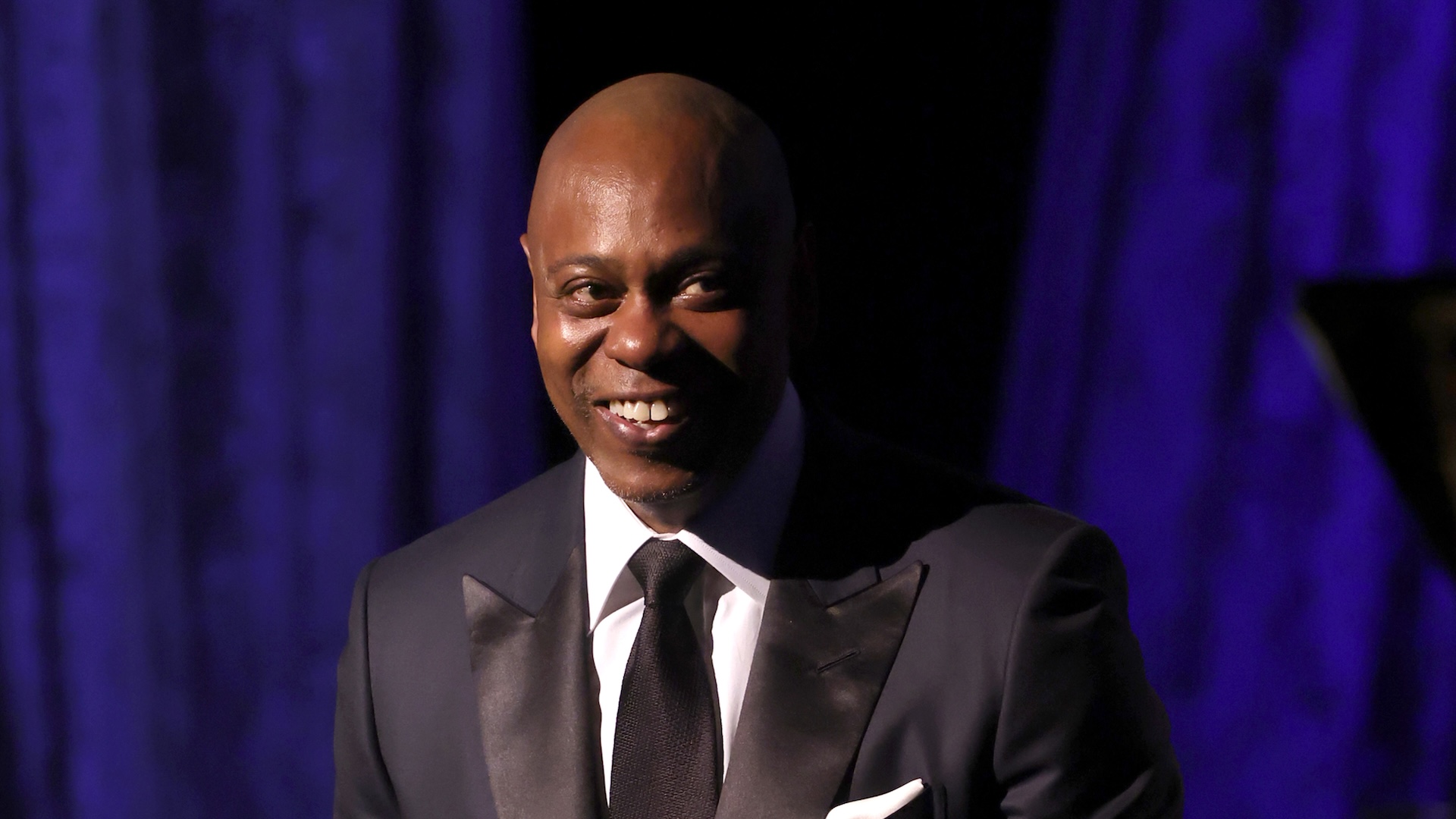 Dave Chappelle performing onstage