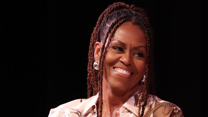 Michelle Obama in front of a black background.