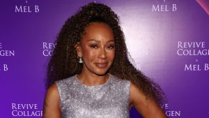 Mel B smiling on the red carpet.