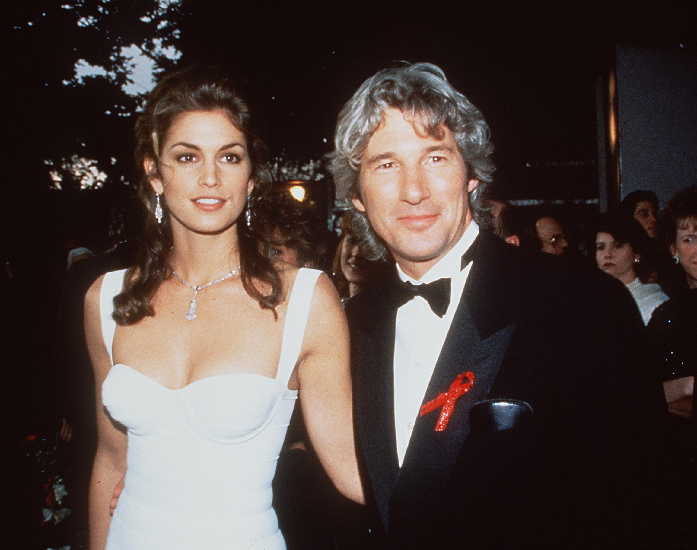 Cindy Crawford and Richard Gere pose together on a red carpet
