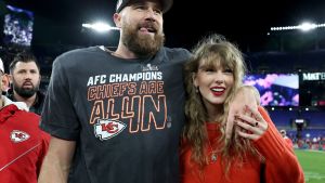 Travis Kelce #87 of the Kansas City Chiefs celebrates with Taylor Swift after a 17-10 victory against the Baltimore Ravens in the AFC Championship Game at M&T Bank Stadium.