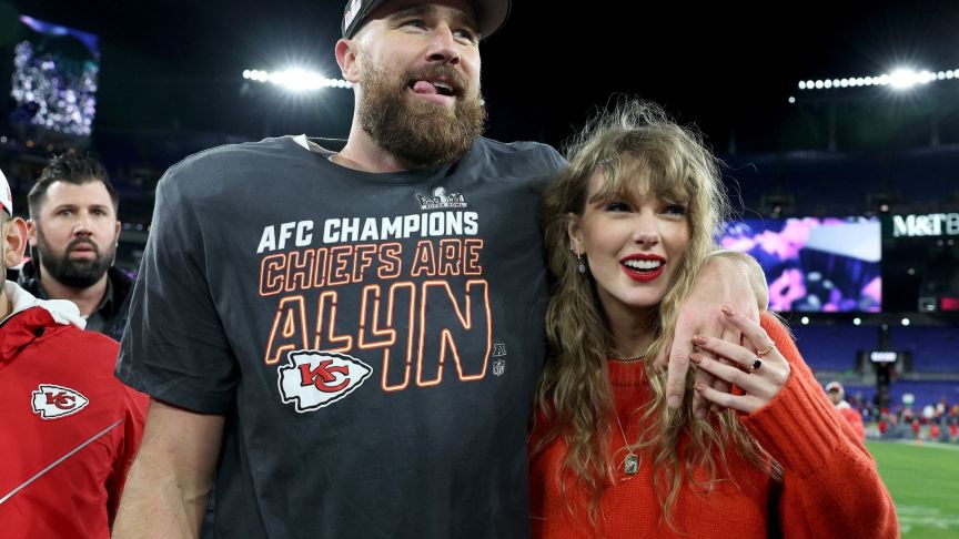 Travis Kelce #87 of the Kansas City Chiefs celebrates with Taylor Swift after a 17-10 victory against the Baltimore Ravens in the AFC Championship Game at M&T Bank Stadium.