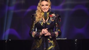 Madonna speaks on stage at the Billboard Women in Music 2016 event.