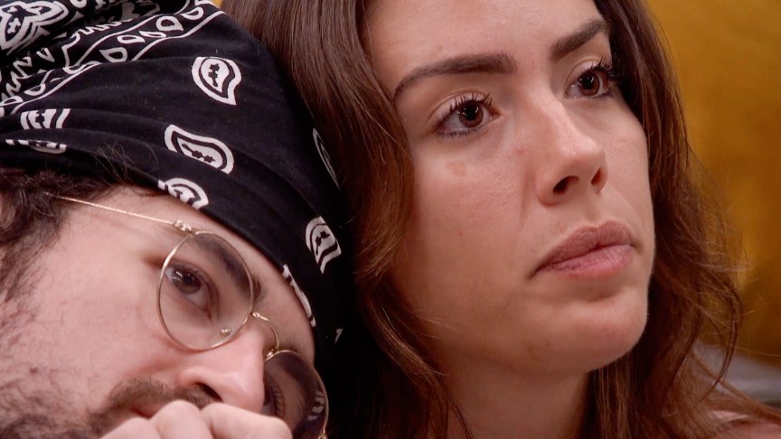 A close-up of Barrett Pfeiffer leaning his head on Dee Valladares' shoulder.
