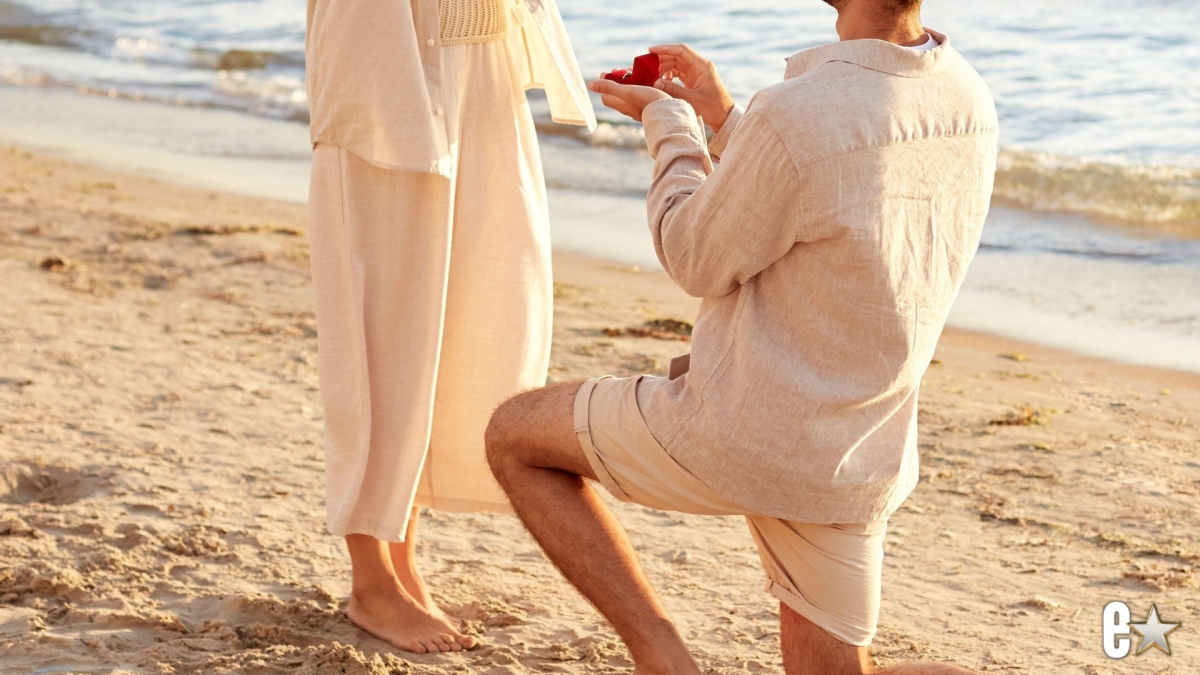 Photo of a couple engaged on the beach