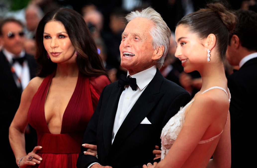 US actor and Honorary Palme d'or of the 76th Festival de Cannes Michael Douglas (C) arrives with his wife British actress Catherine Zeta-Jones (L) and daughter Carys