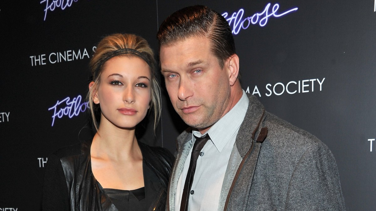 Hailey Bieber and Stephen Baldwin pose together on a red carpet.