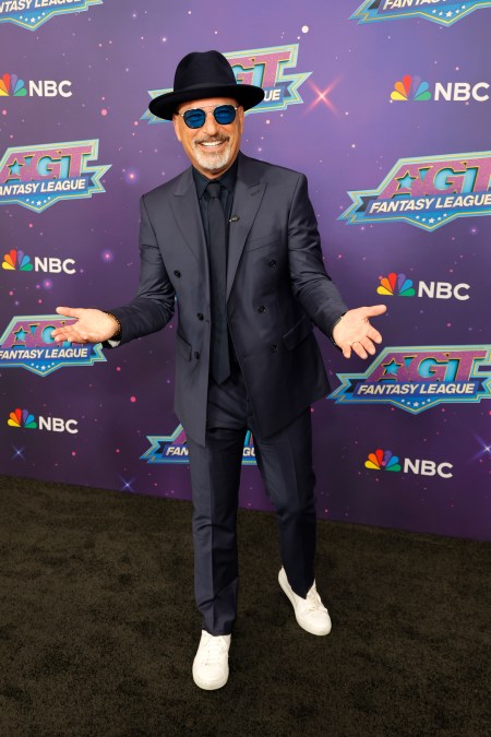 A photo showing Howie Mandel in a black suit and hat at the 'AGT' fantasy league event.