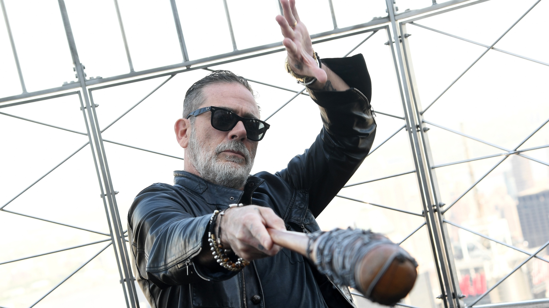 Jeffrey Dean Morgan is on the top floor the Empire State Building, pointing a bat at the camera.