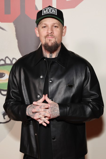 A photo showing Joel Madden at an event, rocking a black leather jacket with black pants.