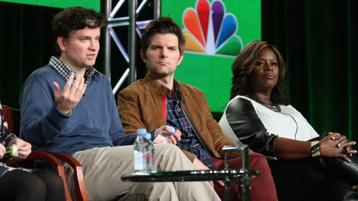 Mike Schur, Adam Scott, and Retta sit on stage.