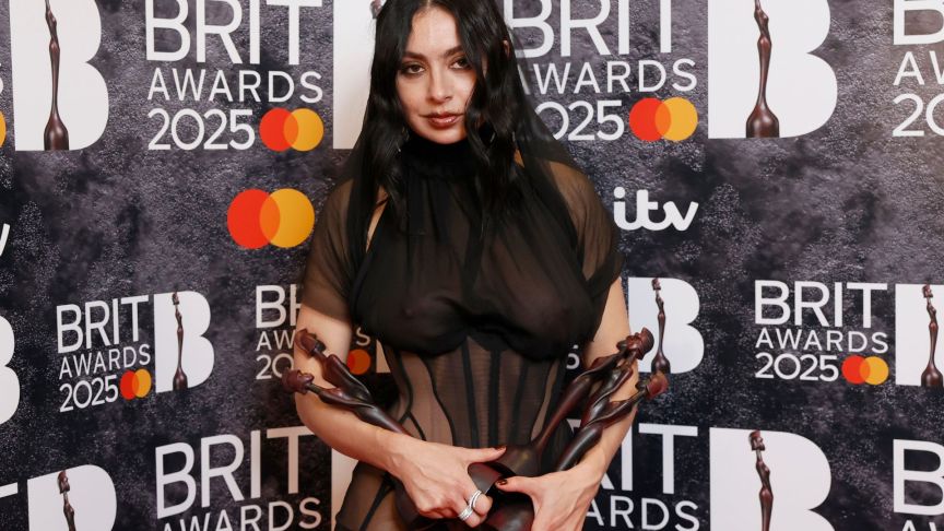 Charli XCX poses in the winners room with the awards for Artist of the Year, Song of the Year, Album of the Year and Dance Act during The BRIT Awards 2025.
