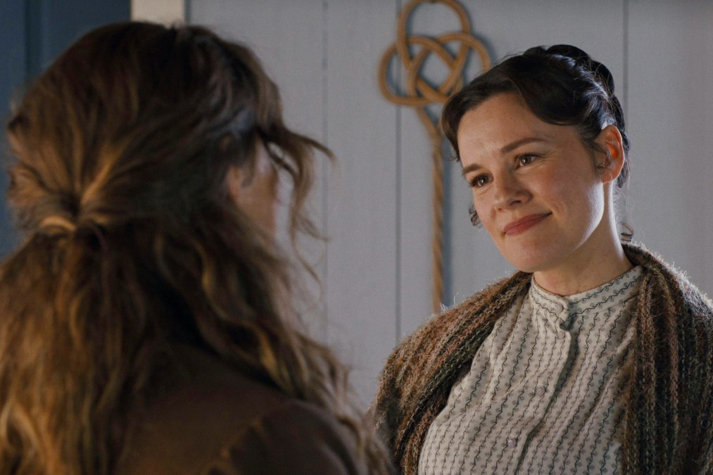 Chelsea Hobbs as Peggy in a white dress and sweater