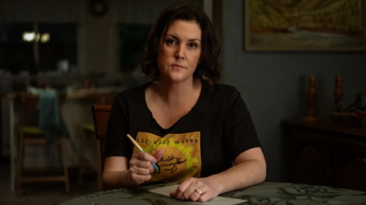 Shauna sits at a table as she writes on paper on 'Yellowjackets'