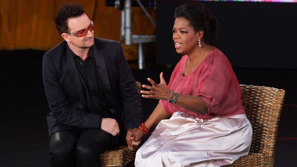 Bono holds hands with Oprah Winfrey